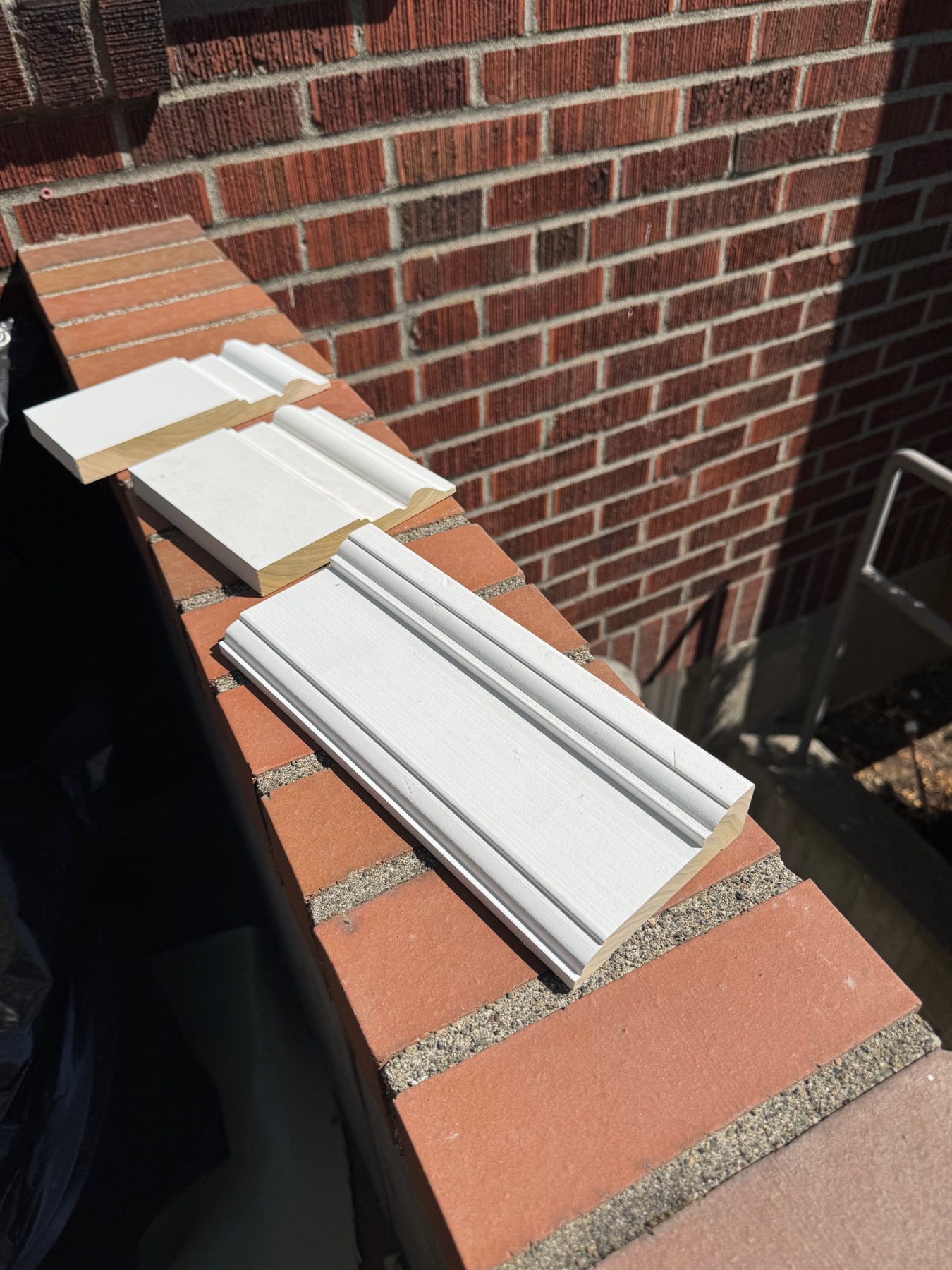 Custom-milled, primed molding profiles laid out ready for installation
